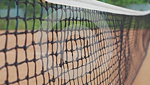 Yellow-green tennis ball hitting net