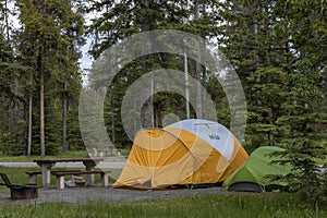 A yellow and green tent in a campsite near Banff