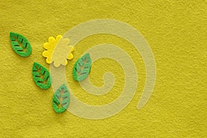 Yellow green textile background from felt with flower and leaves