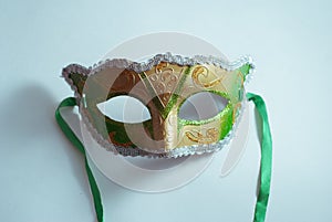 yellow and green Venetian mask on white background