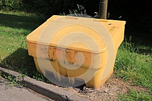 Yellow Grit Salt grit box used for storing salt for use during icy wintry conditions