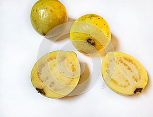 Yellow guava fruits a pair of slice and white background