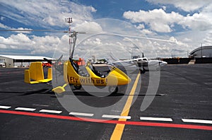 Yellow gyroplane in the international airport photo