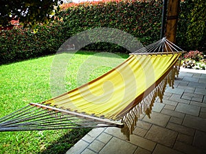 Yellow hammock in the garden of a house