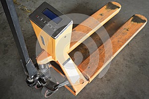 Yellow hand pallet truck or manual hand lift with digital weigh scales