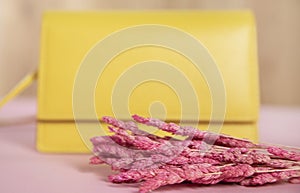 Yellow handbag with flower on table