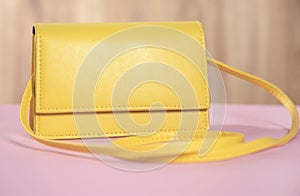 Yellow handbag on the pink background