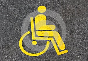 Yellow handicap sign in a parking