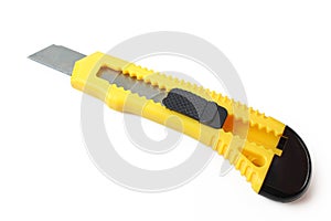 Yellow handle cutter knife isolated on white background. Extended utility blade