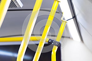 Yellow handle railings inside the bus, passenger transportation