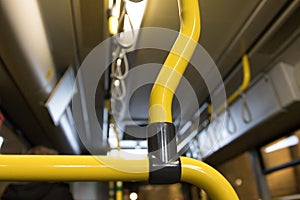 Yellow handles inside a bus