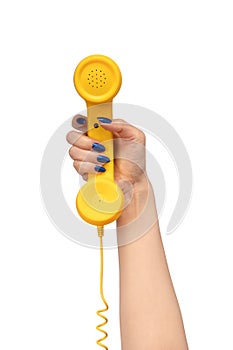 Yellow handset in woman hand isolated on white. Copy space