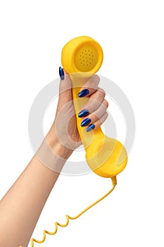 Yellow handset in woman hand isolated on white. Copy space