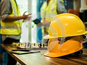 Yellow hard safety helmet hat for safety project of workman as engineer or worker, In the office, safety concept