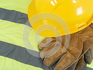 Yellow hardhat, old leather gloves