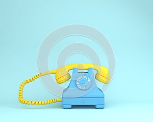 Yellow headphone against blue retro telephone on light blue colo