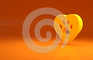 Yellow Heart with animals footprint icon isolated on orange background. Pet paw in heart. Love to the animals