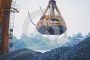 Yellow heavy excavator and bulldozer excavating sand and working during road works, unloading sand and road metal