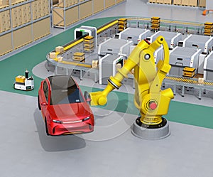 Yellow heavyweight robotic arm carrying red SUV in the assembly factory photo
