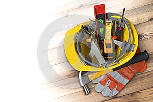 Yellow helmet for construction work and tools on the plank