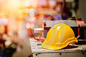 Yellow helmet hardhat safety for factory worker working in danger workplace with space for text photo