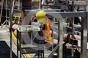 yellow helmet safety in construction site. helmet and reflective vest.