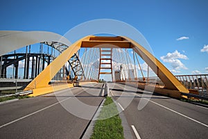 Yellow Hogeweidebrug suspension bridge in Utrecht with seperate lanes for traffic and for busses
