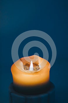 Yellow holiday candle on blue background, luxury branding design and decoration for Christmas, New Years Eve and Valentines Day