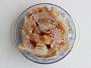 Yellow Honeycomb slice closeup isolated on white background. Raw honey. Cell slice with honey. Cell slice with honey in the