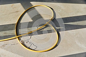 Yellow hose pipe on concrete cement floor.
