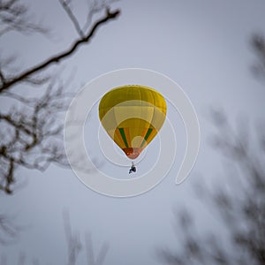 Yellow hot air ballon flying in the sky.