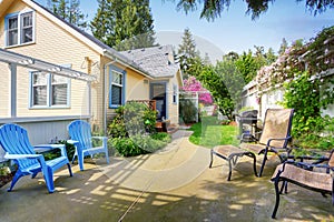 Yellow house backyard area with patio