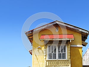 Yellow house on blue sky