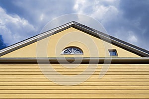 Yellow house semicircular and square window