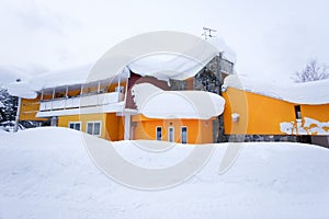 Yellow house in snow