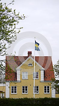 Yellow house with swedish flag.