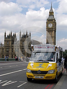 Yellow ice cream car parked near Big Ben