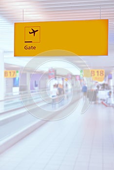 Yellow illuminated sign at airport with gate number