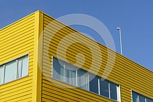 Yellow industrial steel facade under blue sky perspective view