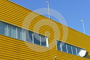 Yellow industrial steel facade under blue sky perspective view