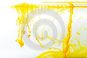 Yellow ink swirling in water, Color drop in water photographed in motion