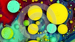 Yellow inks react to form a beautiful structure of paint bubbles. Multicolored Background Liquid Paint. Abstract