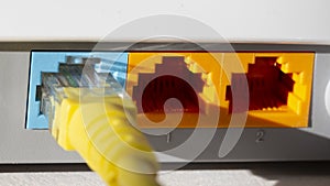 yellow internet cable in blue on the back of the network router