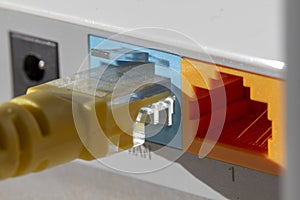 yellow internet cable in blue on the back of the network router