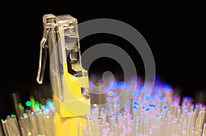 Yellow internet switch close up macro shot , blue , green optical fibres. photo