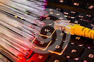 Yellow internet switch on gaming laptops RGB  keyboard, glowing optical fibres