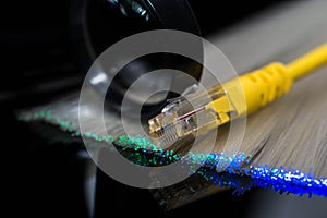 Yellow internet switch , glowing optical fibres, magnifying glass