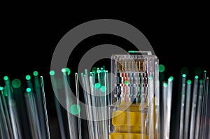 Yellow internet switch, green optical fibres close up macro shot