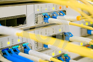 Yellow Internet wires are connected to the central router interfaces. There are many optical patchcards in the data center server