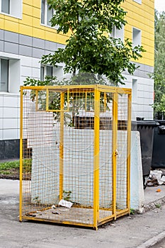 Yellow iron mesh for plastic waste for recycling near housing block